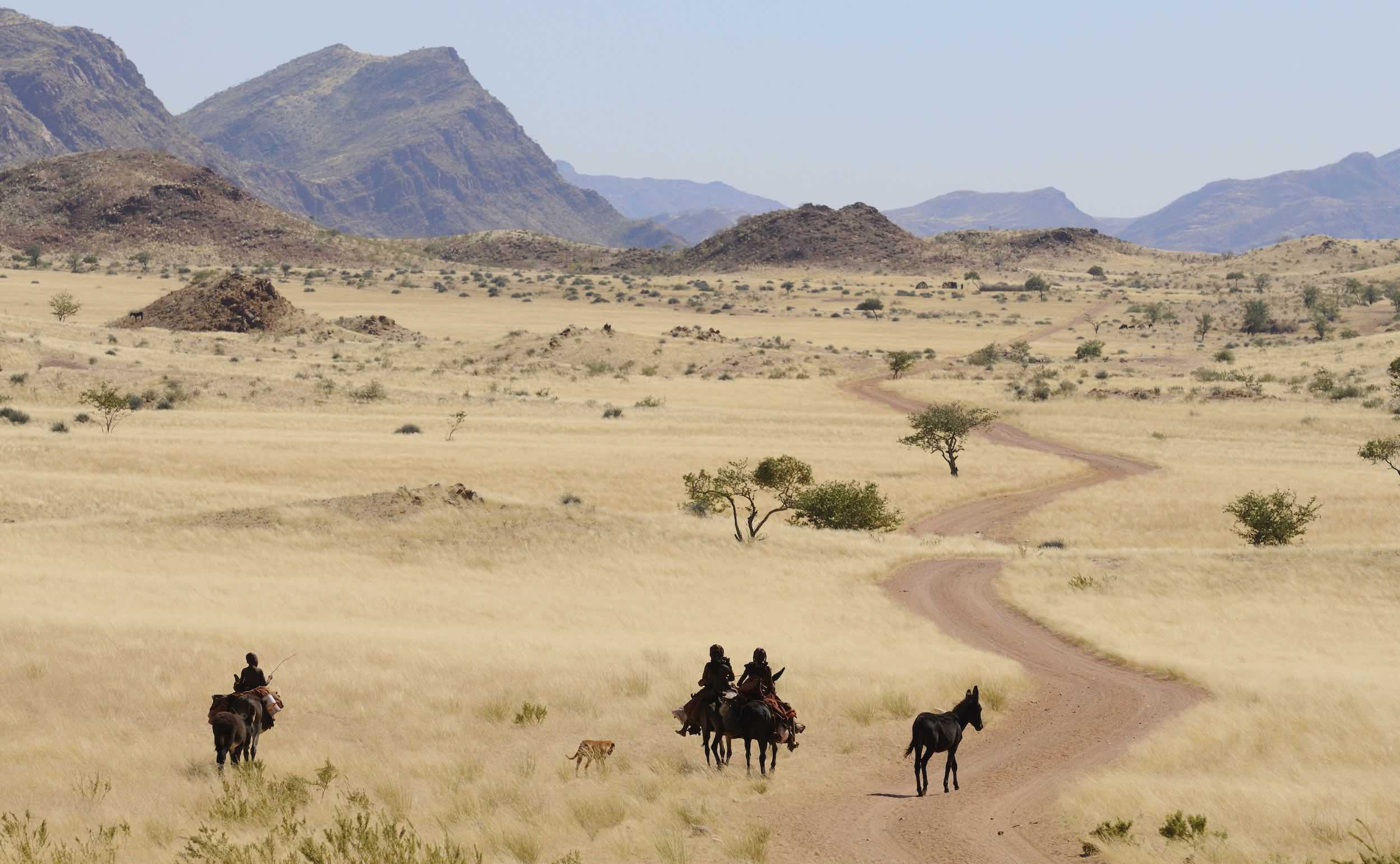 Local people riding through stunning Namibian scenery.